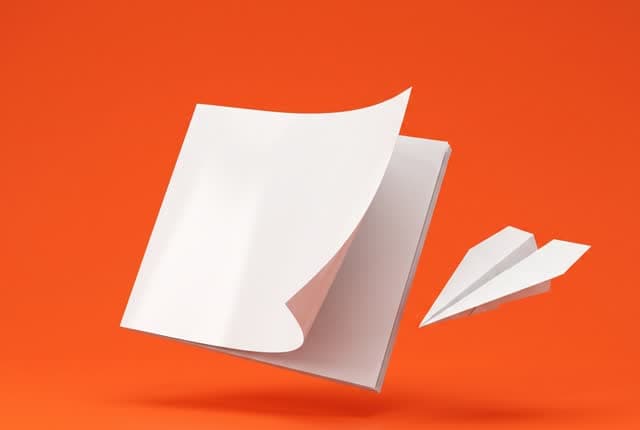 A guide booklet and a paper airplane