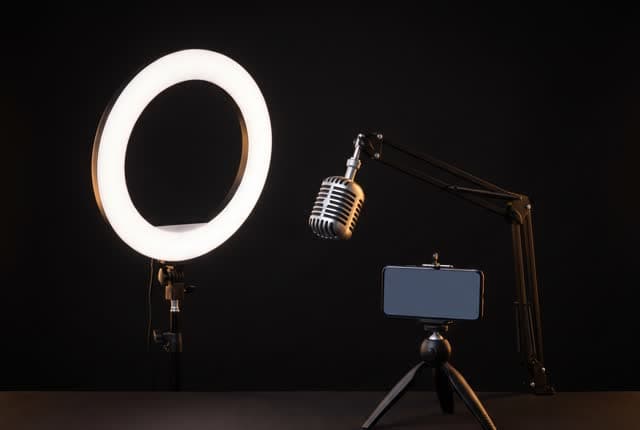 A ring light, microphone and phone on a tripod